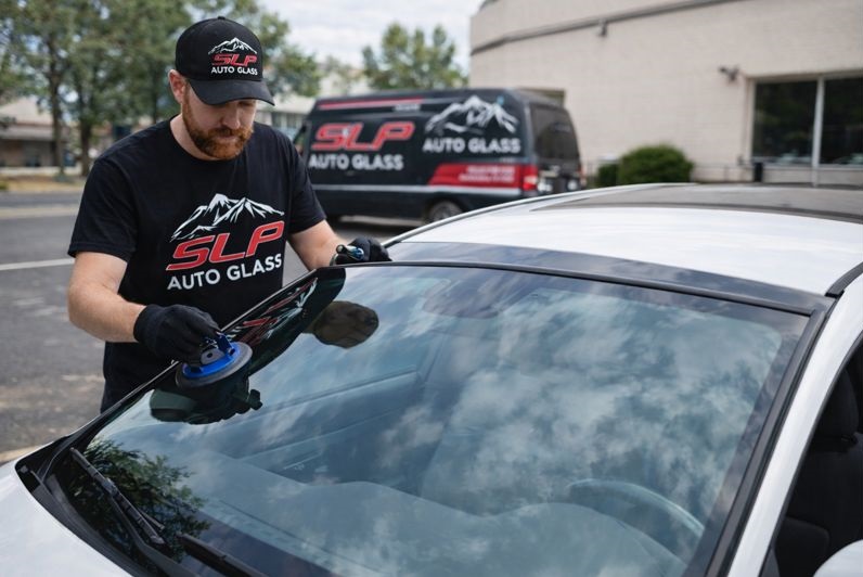 SLP Auto Glass technician replacing a windshield on a car in Lakewood CO