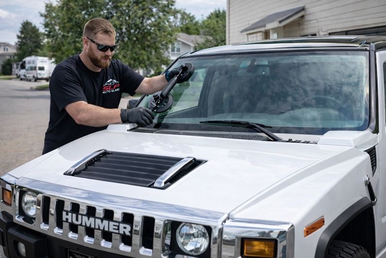 Hummer H2 windshield replacement by SLP Auto Glass technician