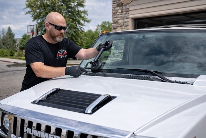 Hummer windshield replacement by SLP Auto Glass technician installing a new windshield