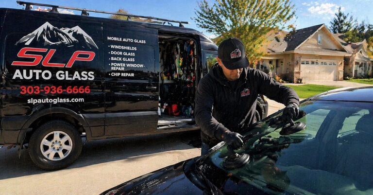 SLP Auto Glass technician installing windshield with mobile glass warranty service