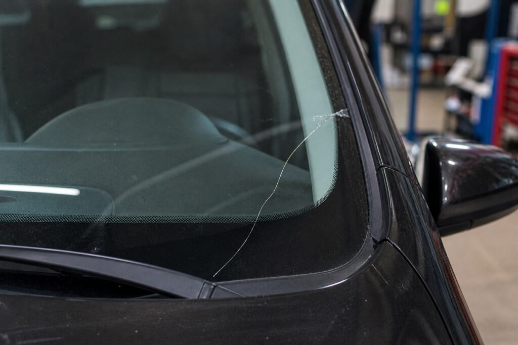 Windshield edge crack near frame showing structural damage by SLP Autoglass