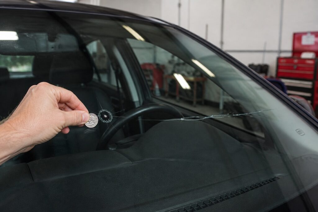 Windshield crack size comparison using coin for repair assessment by SLP Autoglass